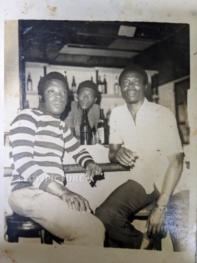 Bar scene with three men: damaged edges rebuilt and the image colourised